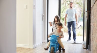Excited Children Arriving Home With Father