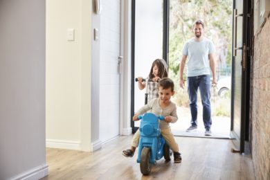 Excited Children Arriving Home With Father
