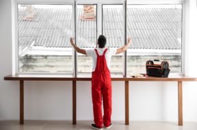 Young worker checking window after repair