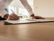 Businessman signing insurance or legal document