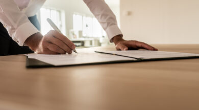 Businessman signing insurance or legal document