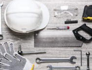 Set of construction tools on light wooden background