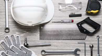 Set of construction tools on light wooden background