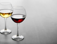 Glasses of wine on wooden background