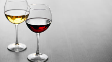 Glasses of wine on wooden background