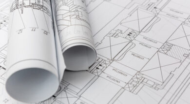 Technical drawings with blueprints in rolls close up. Engineerin