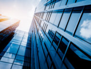 Modern office building against blue sky, blue tone.