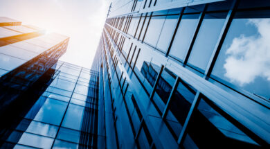 Modern office building against blue sky, blue tone.