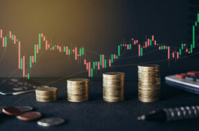 Stack of money coin on office desk with trading graph. Business