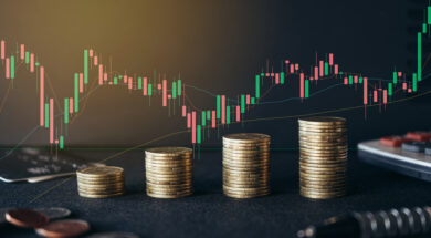 Stack of money coin on office desk with trading graph. Business