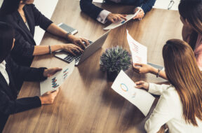 Businesswomen in Meeting, Laptop Computer on Table