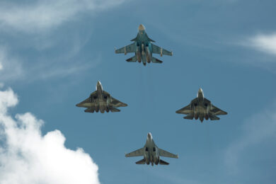 Group of jet fighters make a figure in air during airshow. Aerob