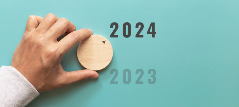 Man hand choose number 2024 on blue background. countdown to 202