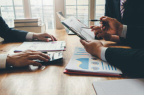 Group of business people meeting together to assess business pro