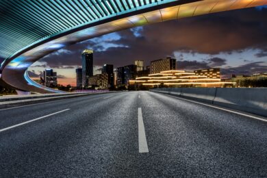 Asphalt,Road,And,Bridge,With,Modern,City,Skyline,At,Night