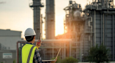 Manager Engineering in standard safety uniform working in gas turbine electric power plant during sunset or morning time background