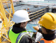 Two,People,Architect,Engineer,Worker,On,Major,Constructionsite,Checking,Progress