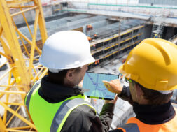 Two,People,Architect,Engineer,Worker,On,Major,Constructionsite,Checking,Progress